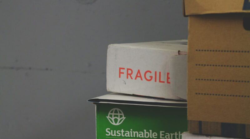 White cardboard box carrying a red Fragile label, showing the kind of handling symbol packaging needs